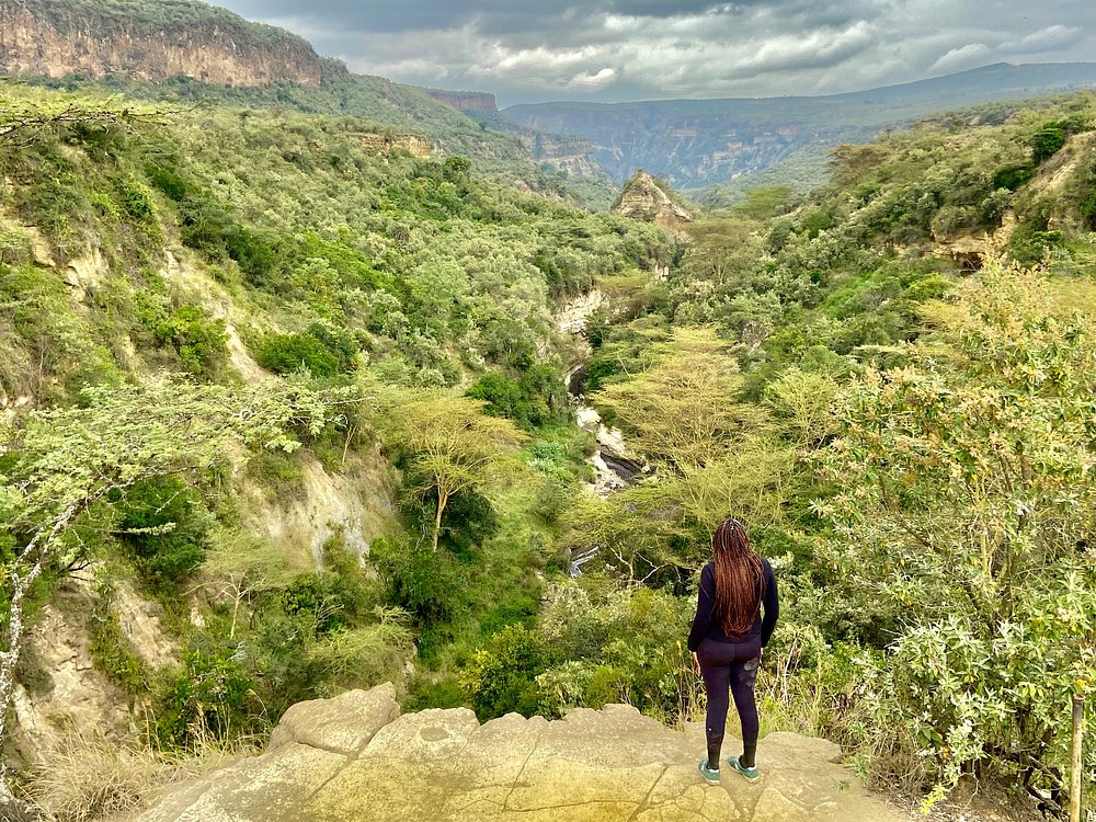 Visitor standing on the rim of Hell's Gate Gorge Kenya
