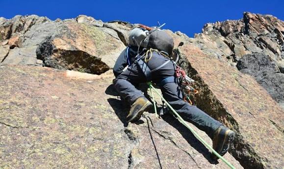 Technical rock climber ascending Batian or Nelion peak on Mount Kenya